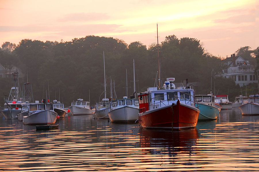 Blog - Boats Departing from Docks into Open Sea at Sunset in Maine